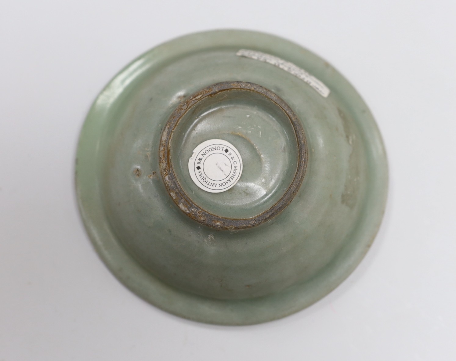 A Chinese Longquan celadon dish, Song-Yuan dynasty, 12cm. Provenance - Dr H. Ginsburg collection